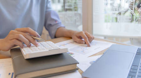 Accounting businesswomen are calculating income-expenditure and analyzing real estate investment...