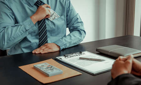 Opposition to wrongdoing and social injustice, Businessmen give bribes to employees to sign approvals through illegal projects, Fraud and corruption Or something illegal.の写真素材