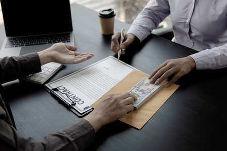 Opposition to wrongdoing and social injustice, Businessmen give bribes to employees to sign approvals through illegal projects, Fraud and corruption Or something illegal.の写真素材