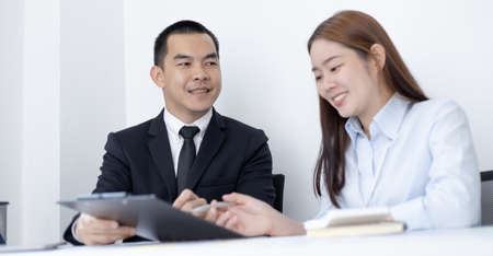 Brainstorm team, Marketers and financial accountants are discussing and analyzing charts to plan strategies to meet customer needs, Computer technology for business concept.の写真素材