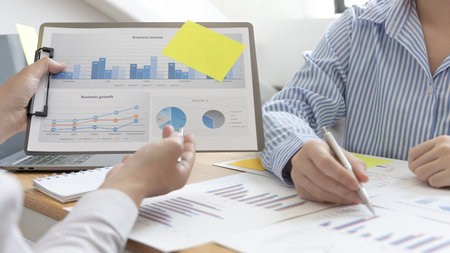 Business team meeting, Marketers and financial accountants are discussing and analyzing charts to plan strategies to meet customer needs, Brainstorming and business discussions.の写真素材