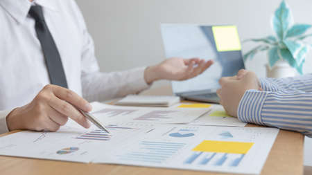 Business team meeting, Marketers and financial accountants are discussing and analyzing charts to plan strategies to meet customer needs, Brainstorming and business discussions.の写真素材