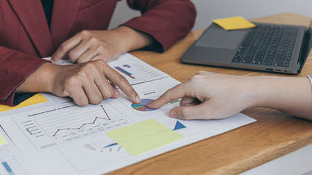 Business team meeting, Marketers and financial accountants are discussing and analyzing charts to plan strategies to meet customer needs, Brainstorming and business discussions.の写真素材