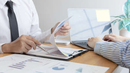 Business team meeting, Marketers and financial accountants are discussing and analyzing charts to plan strategies to meet customer needs, Brainstorming and business discussions.の写真素材