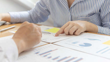 Business team meeting, Marketers and financial accountants are discussing and analyzing charts to plan strategies to meet customer needs, Brainstorming and business discussions.の写真素材
