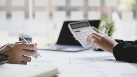 Brainstorm team, Marketers and financial accountants are discussing and analyzing charts to plan strategies to meet customer needs, Computer technology for business concept.の写真素材