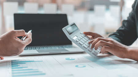 Brainstorm team, Marketers and financial accountants are discussing and analyzing charts to plan...