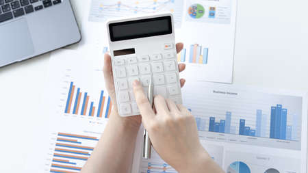 Accounting businesswomen are calculating income-expenditure and analyzing real estate investment...