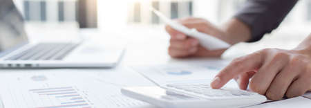 Business men are calculating real estate investment expenditures and analyzing the company's finances in line with the global economy, Analysis of financial accounting investment concept.の写真素材