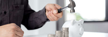 Businessmen use the power savings hammer to save money to invest in new businesses, Economic crisis bankruptcy and investment failed concept.の写真素材