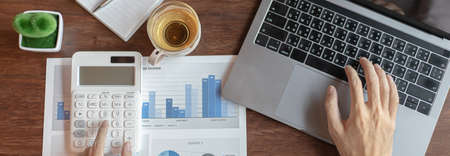 Business men are calculating real estate investment expenditures and analyzing the company's finances in line with the global economy, Analysis of financial accounting and real estate investment concept.の写真素材