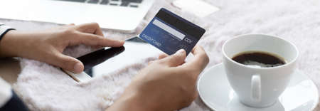 Young businesswoman uses a credit card to shop online and pay with a mobile phone, Buy online, Shopping Online concept.の写真素材