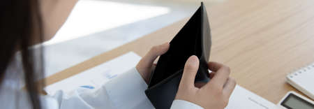 Girl has no money in her purse, Bad economy, poor financial, Low money, bankrupt, Out of money.の写真素材