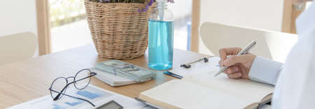 Accounting businessmen are calculating income-expenditure and analyzing real estate investment data, Detention periods or social distances, Alcohol bottle, Financial and tax systems concept.の写真素材