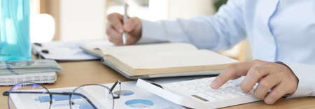 Businessmen analyze market data and calculate the cost of buying-selling products for a client's company, Professional marketing and financial accountants concept.の写真素材