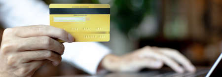 Women use laptop to register online purchases using credit card payments, Convenience in the world of technology and the internet, Shopping online and banking online concept.の写真素材