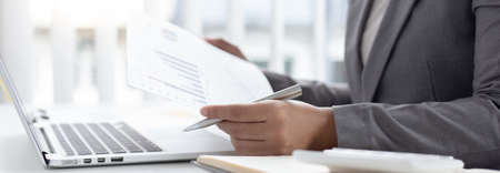 Businessmen analyze market data and calculate the cost of buying-selling products for a client's...