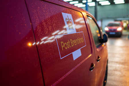 SWANSEA, WALES, UK - DECEMBER 12, 2020: Royal Mail red van with the Welsh equivalent Post Brenhinol...