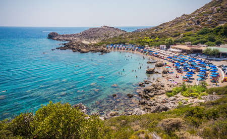 Beautiful Ladiko bay Beach with clear blue water near Faliraki, Rhodes island, Greece on a sunny summer day.の写真素材