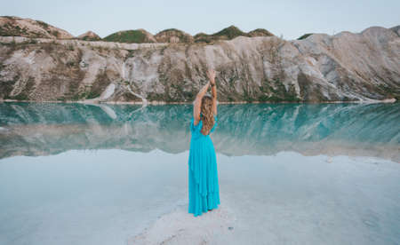 Girl in a blue dress at Volkovysk chalk pits or Belarusian Maldives. Famous chalk quarries near Vaukavysk, Grodno region, Belarus. Developed for the needs of Krasnaselski plant construction materials.の写真素材