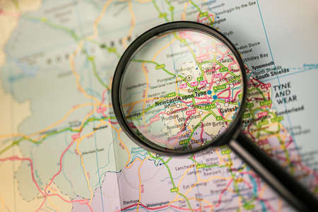 Close-up map of Newcastle upon Tyne through black magnifying glass, city in England, United Kingdomの写真素材