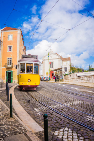 LISBON, PORTUGAL - MARCH 25, 2017: Popular tourist old yellow vintage tram number 28 on the street of Lisbon, Portugalのeditorial素材