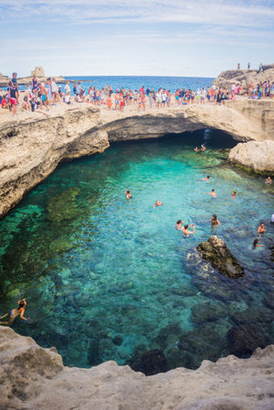 Lecce, Italy - September 12, 2017: Grotta Della Poesia or Cave of Poetry. People swimming in a natural sea cave in Roca Vecchia on the Adriatic coastline, Apulia, Italy.のeditorial素材