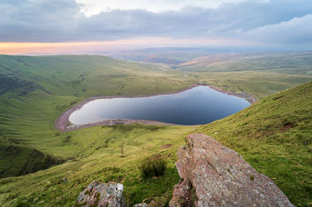 Llyn y Fan Fach lake top view on sunset. Brecon Beacons National Park. Black Mountain, Carmarthenshire, South Wales, the United Kingdom. No people.の写真素材