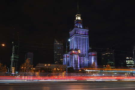 Palace of Culture and Science illuminated by night in Warsaw city center. Traffic light and cars in motion on long exposure. Warsaw, Poland - October 23, 2021のeditorial素材