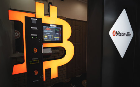 Bitcoin ATM in a mall allows to buy and sell Bitcoin crypto. Orange BTC cryptocurrency exchange machine. Warsaw, Poland - October 23, 2021のeditorial素材