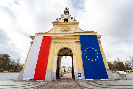 Polish and European Union flags on the entrance gate to the Branicki Palace in Bialystok, Poland. Poles defend EU membership fearing Polexit. Bialystok, Poland - October 22, 2021.の写真素材