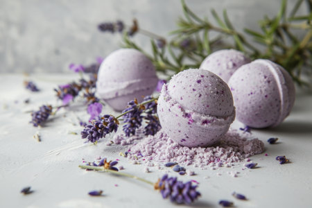 Natural Purple bath bombs with dried lavender buds by fresh sprigs on a light concrete background, for organic handmade cosmetic shops.の素材