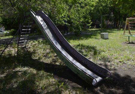 Old metal children's slide in the old district of Magnitogorsk, Russia.の写真素材