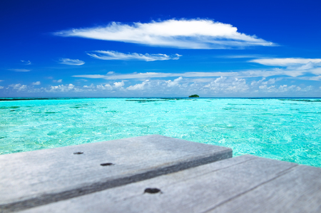 Tropical seascape of the fresh turquoise sea water, deep blue sky and white clouds in Maldives.の写真素材