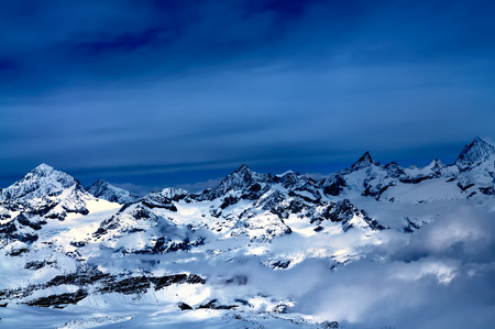 Aerial view of beautiful Swiss Alps surrounded by floating cloud in Zermatt, Switzerland.