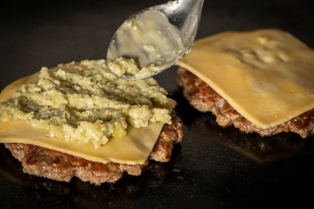 Pancakes with cheese and pesto on a black background. Toned.の写真素材