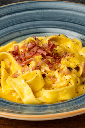 close up of a plate of pasta carbonara with bacon and cheeseの写真素材