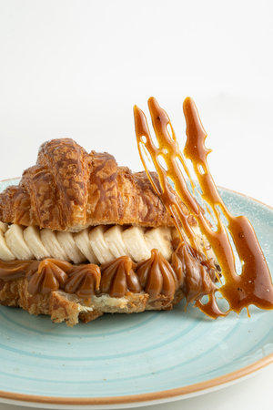 Croissant with caramel on a white background. Desertの写真素材