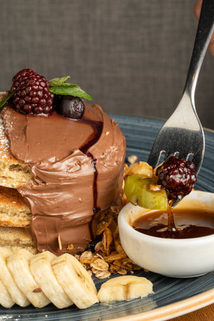 Honey toast with chocolate and fruits on a plate, close upの写真素材