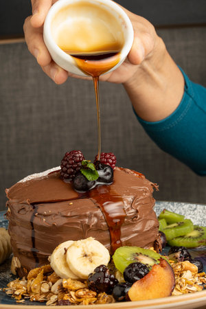 Chocolate cake with fruits and nuts on a dark background, selective focusの写真素材