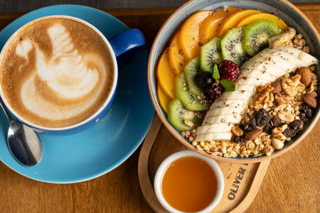 Healthy breakfast with granola, banana, kiwi and coffeeの写真素材