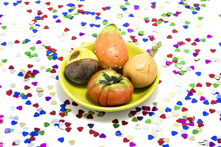 Marzipan sweets, surrounded by so many multicolor heartsの写真素材
