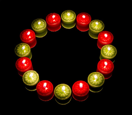 Many candles on circle, reflected, on dark backgroundの写真素材
