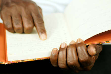 afro man reading his journal の写真素材