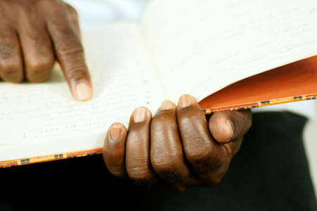 afro man reading his journal の写真素材