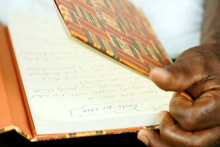afro man reading his journal の写真素材