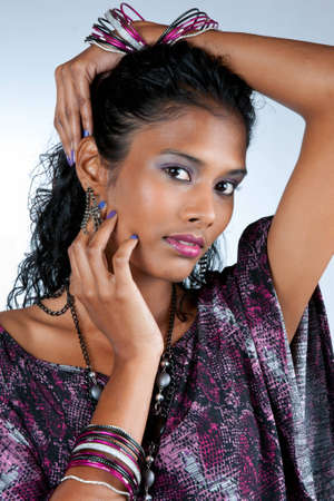 beautiful woman of east indian ancestry in a contemporary pose looking at you の写真素材