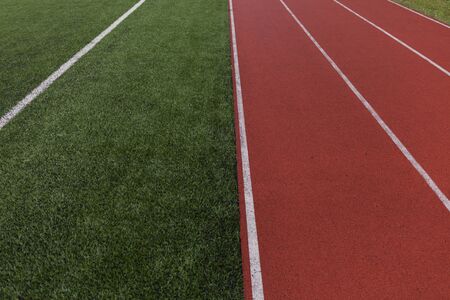 Red running track in stadium. Running track on blue sky. field run in stadium background.