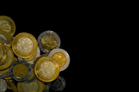 lot of mexican coins with black backgroundの写真素材