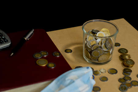 money face mask bills and coins with jar of glass